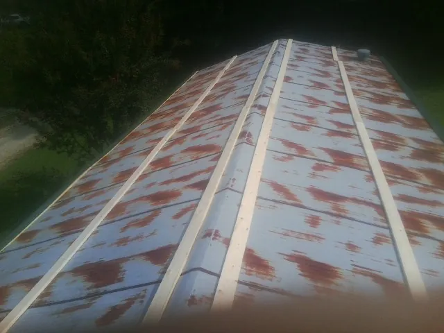 Rusted metal roof panels with new wood purlins before replacement — Storm Damage Roof Repair in Dietrich by Roofing Brothers